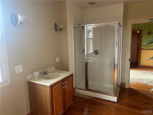 bathroom featuring hardwood / wood-style floors, vanity, and an enclosed shower