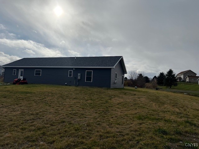 rear view of house featuring a yard