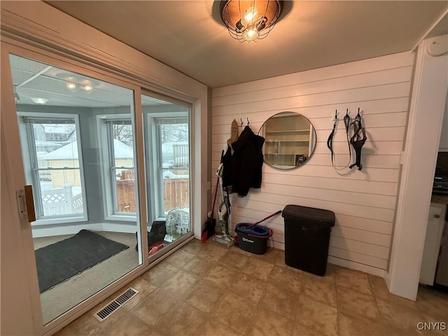 mudroom with wood walls