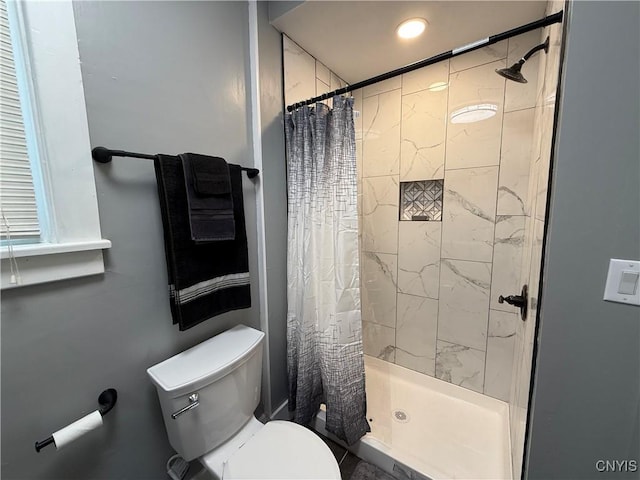 bathroom with a shower with curtain and toilet