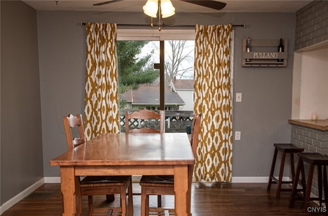 dining area with ceiling fan and dark hardwood / wood-style floors