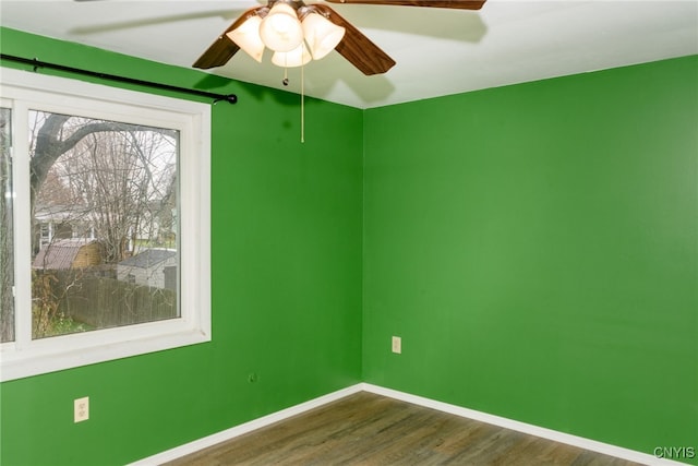 empty room featuring ceiling fan and dark hardwood / wood-style flooring