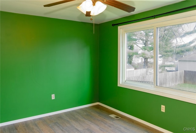 empty room with hardwood / wood-style floors and ceiling fan