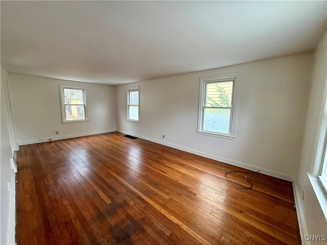 spare room featuring wood-type flooring