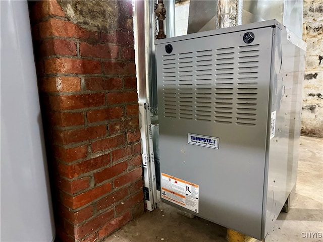 utility room featuring heating unit