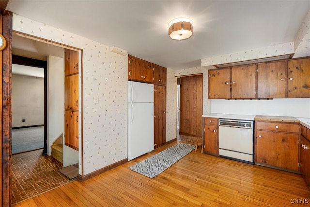 kitchen with light hardwood / wood-style flooring and white appliances