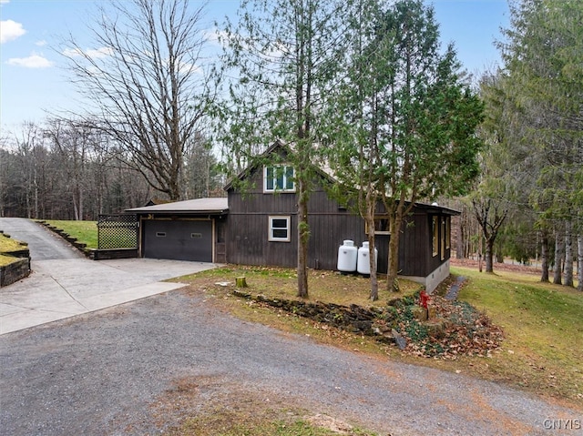 view of home's exterior featuring a lawn and a garage