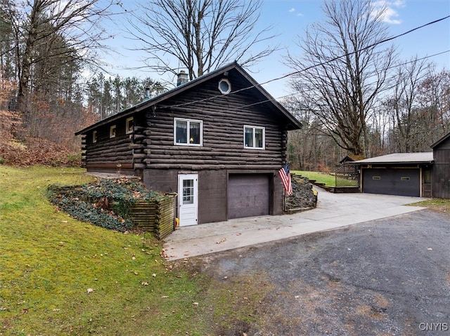 view of property exterior with a garage and a lawn