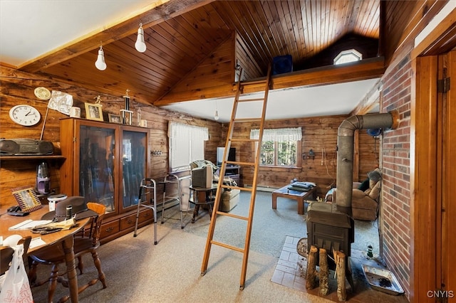 office with a wood stove, wooden ceiling, wood walls, lofted ceiling, and carpet