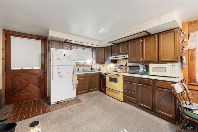 kitchen with sink and white appliances