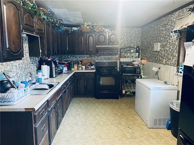 kitchen with dark brown cabinets, black range with electric stovetop, sink, and fridge