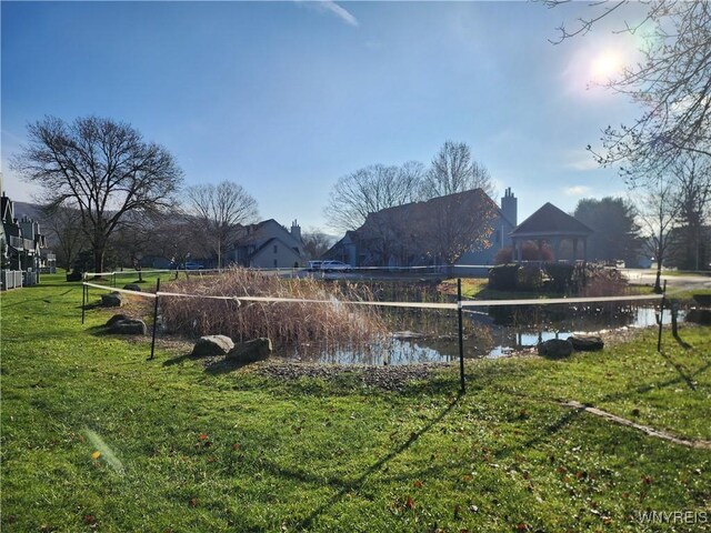 exterior space featuring a gazebo and a water view