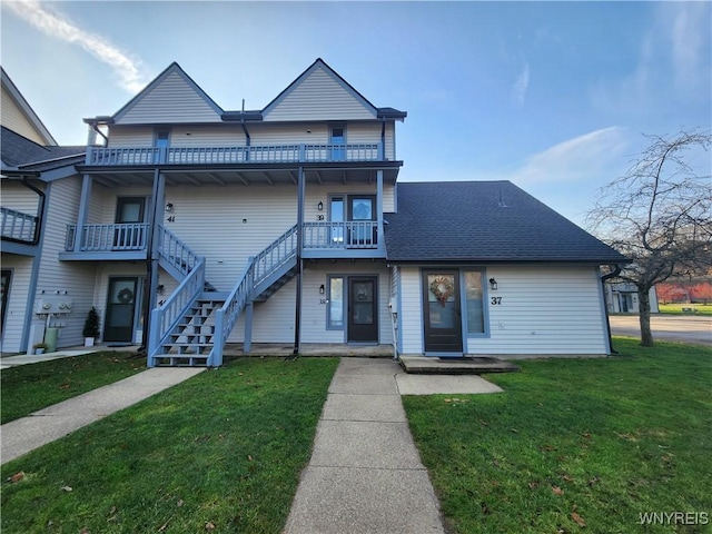 multi unit property featuring a front yard and a balcony