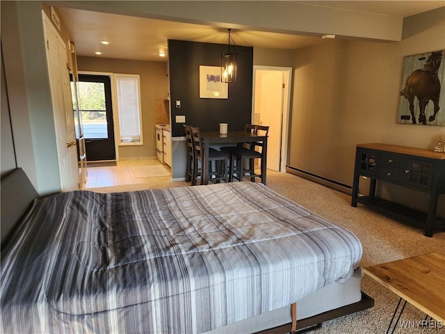 bedroom featuring light colored carpet and baseboard heating