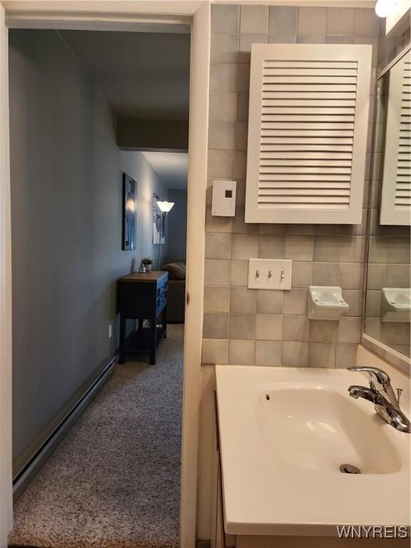 bathroom with vanity and tile walls