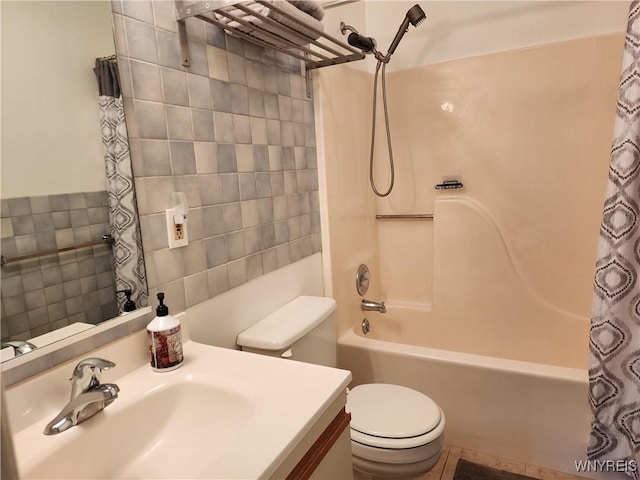 full bathroom featuring tile patterned flooring, vanity, toilet, and shower / bath combo with shower curtain