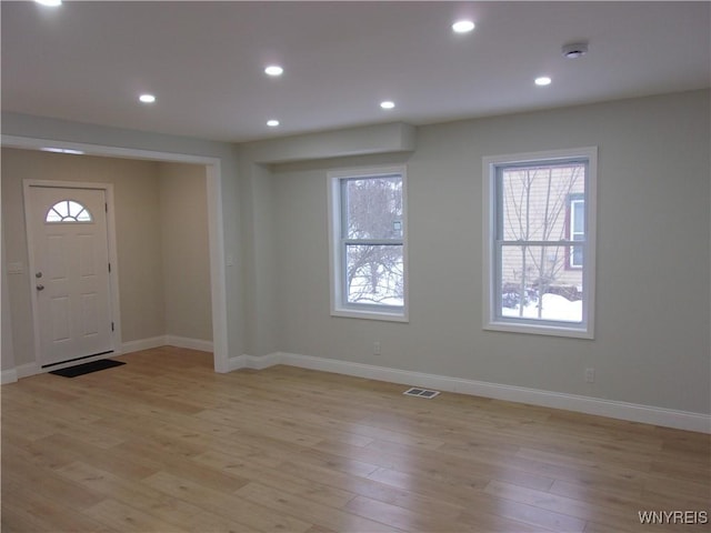 entrance foyer featuring plenty of natural light and light wood-type flooring