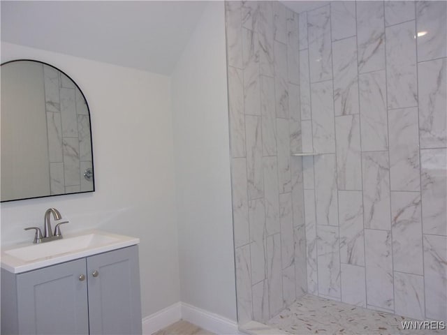 bathroom featuring vanity and a tile shower