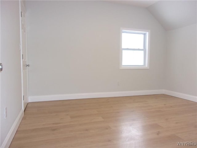 additional living space with lofted ceiling and light wood-type flooring