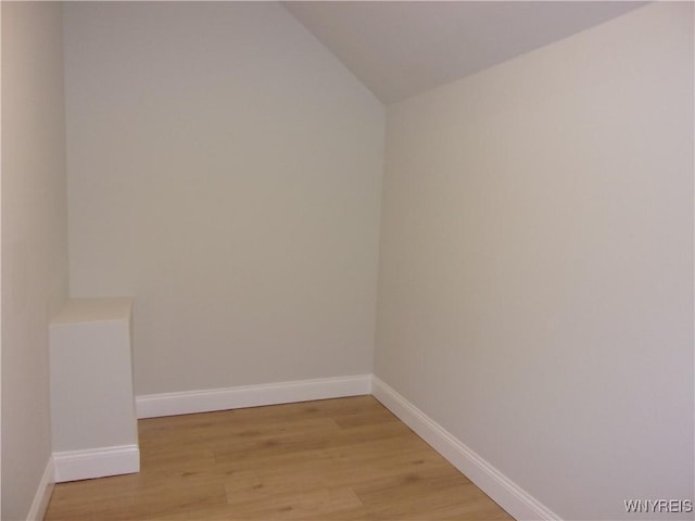 empty room featuring lofted ceiling and light hardwood / wood-style flooring