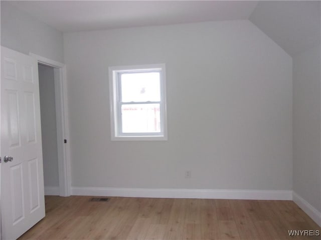 bonus room featuring light hardwood / wood-style floors and vaulted ceiling