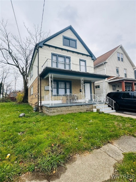 view of front of house featuring covered porch and a front lawn