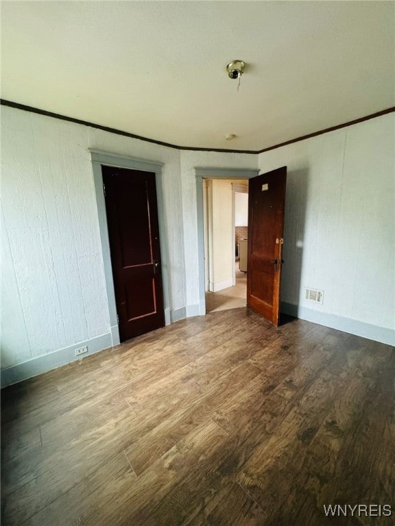 spare room with hardwood / wood-style flooring and ornamental molding