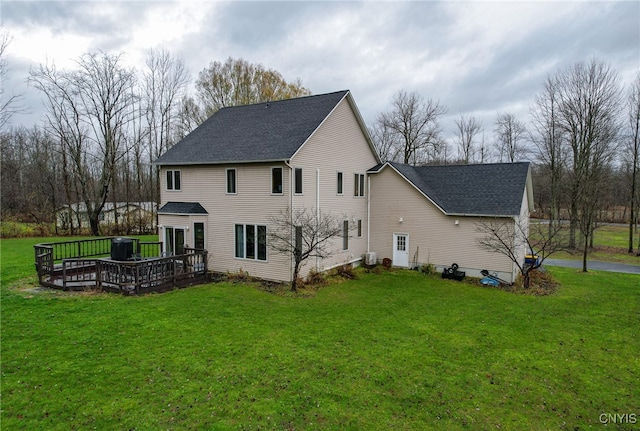 back of property featuring a lawn and a deck