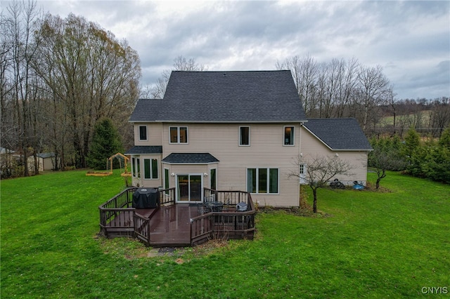 back of house with central AC unit, a yard, and a wooden deck