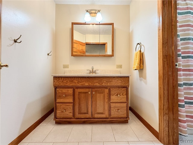 bathroom featuring tile patterned flooring and vanity