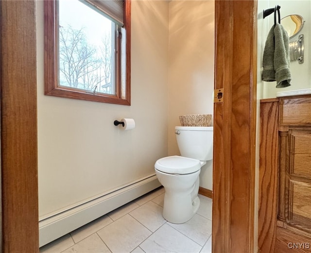 bathroom featuring tile patterned floors, toilet, and a baseboard heating unit