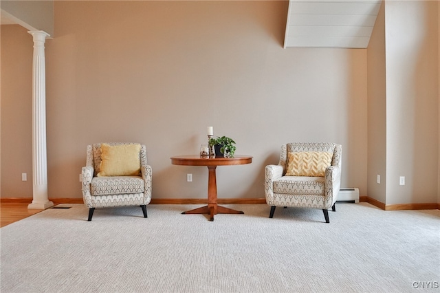 sitting room with ornate columns, carpet floors, and a baseboard heating unit