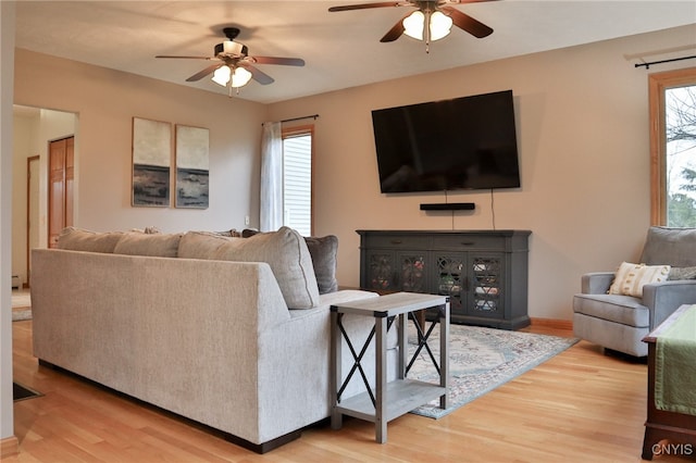 living room featuring hardwood / wood-style floors, plenty of natural light, and ceiling fan