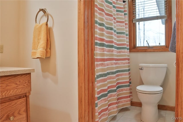 bathroom with tile patterned floors, walk in shower, vanity, and toilet