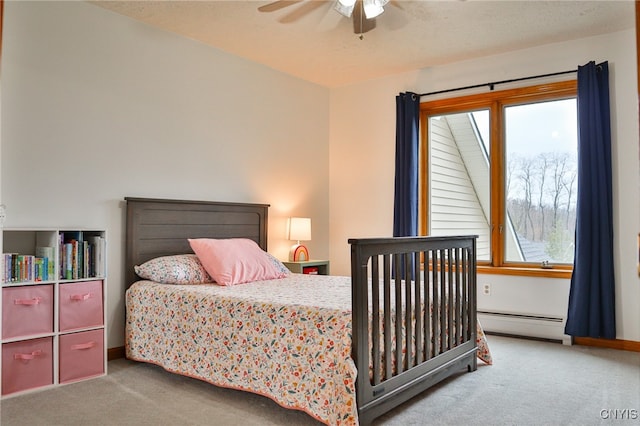 carpeted bedroom featuring ceiling fan and a baseboard heating unit