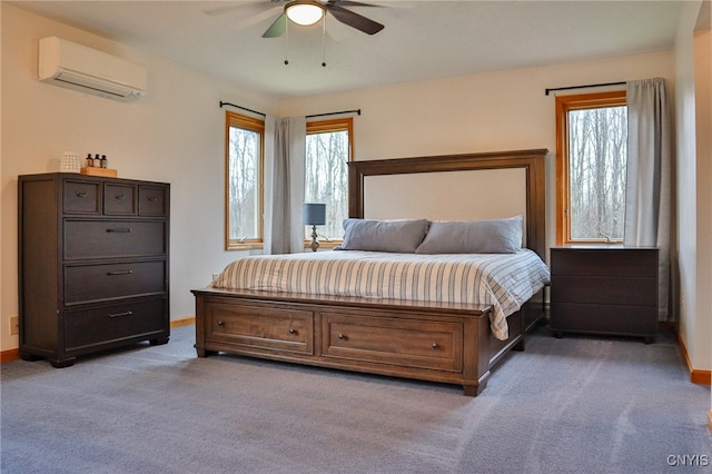 carpeted bedroom featuring ceiling fan and a wall mounted air conditioner