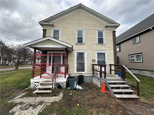 rear view of property with a lawn and a wooden deck