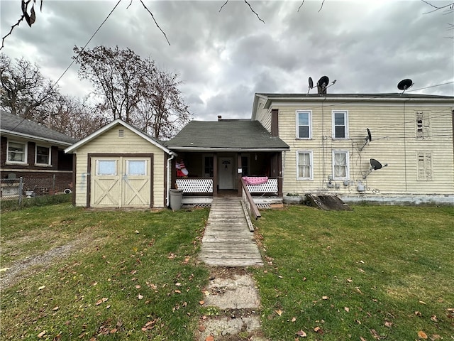 back of house featuring a lawn and a storage unit