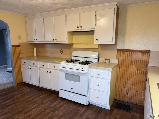 kitchen with white cabinets, dark hardwood / wood-style flooring, and white range with gas cooktop