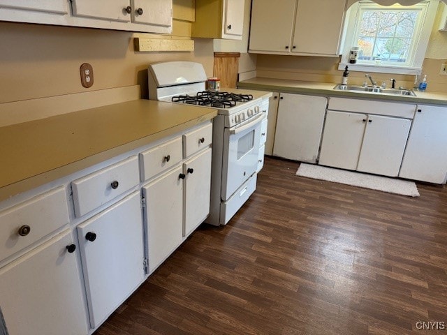 kitchen with white cabinetry, dark hardwood / wood-style flooring, white range with gas stovetop, and sink