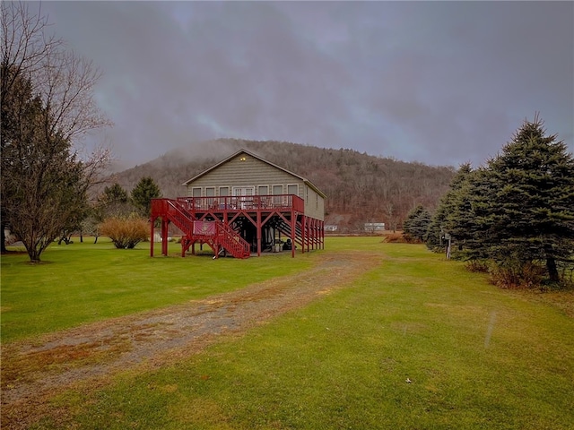 view of property's community featuring a deck with mountain view and a yard