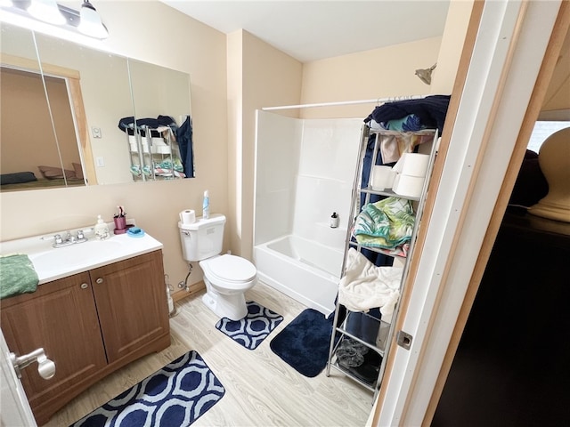 full bathroom with vanity, hardwood / wood-style flooring, toilet, and shower / washtub combination