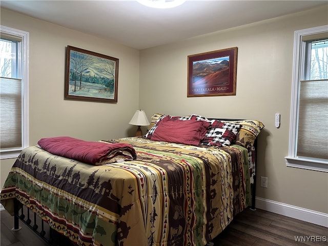 bedroom with dark hardwood / wood-style floors