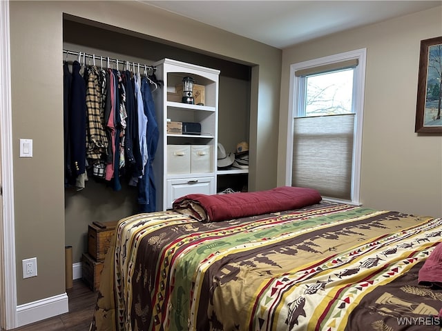 bedroom with dark wood-type flooring