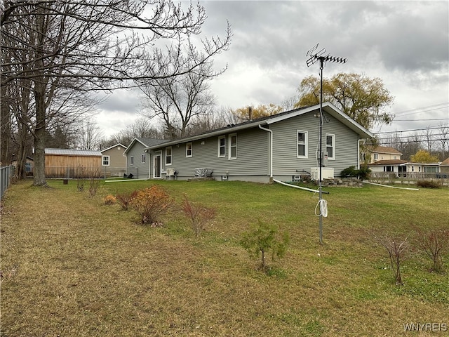 rear view of property with a yard