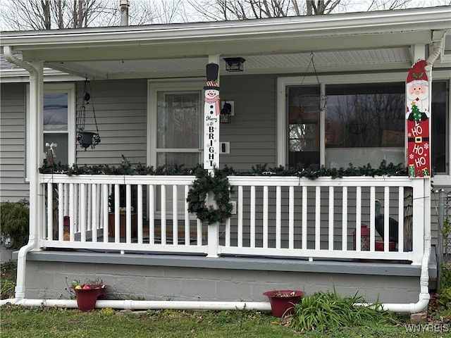 view of exterior entry featuring covered porch