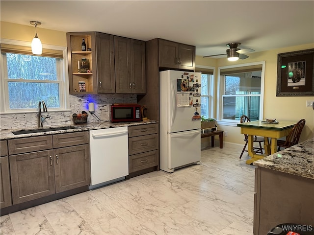 kitchen featuring ceiling fan, sink, dark stone countertops, white appliances, and decorative backsplash