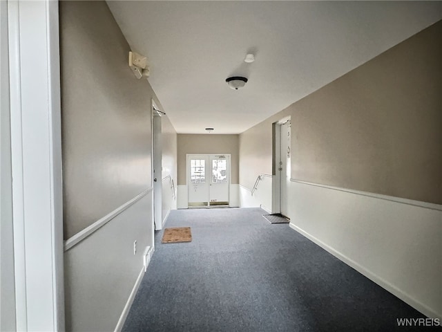 hall featuring carpet floors and french doors