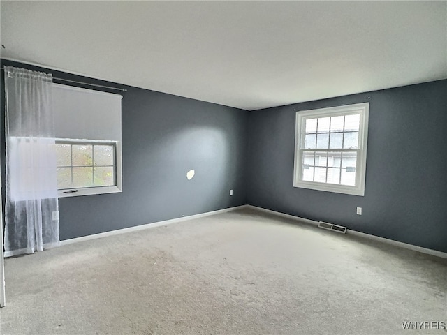 carpeted empty room featuring a healthy amount of sunlight