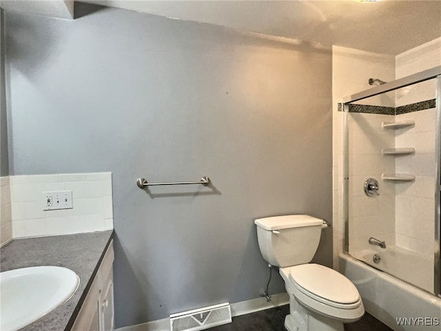 full bathroom with vanity, tiled shower / bath combo, and toilet